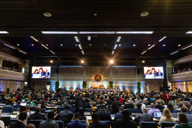 People sitting in a large conference hall
