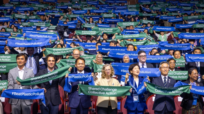 Delegates - including UNEP Executive Director Inger Andersen - hold up banners that read "Beat Plastic Pollution" and "Shared Challenge, Collective Action" at World Environment Day celebrations in Jeju, Republic of Korea