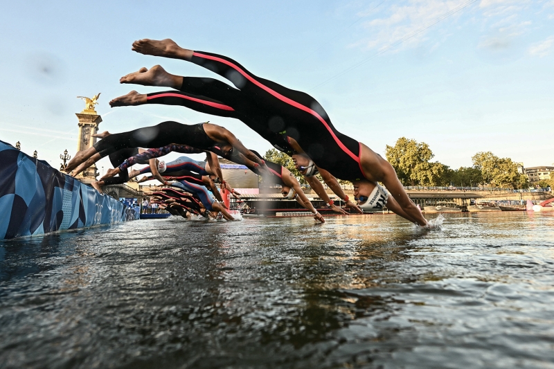 People diving into a river