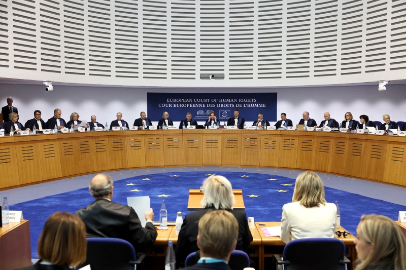Several judges sitting behind a dias