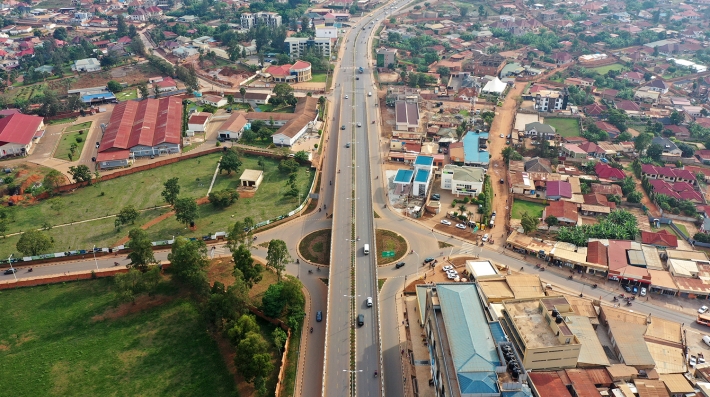 An overhead view of a highway cutting through a city 