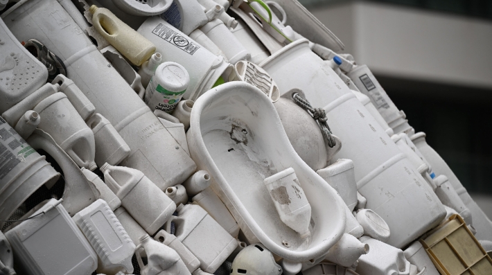 Zoom in on a sculpture made of plastic waste. 