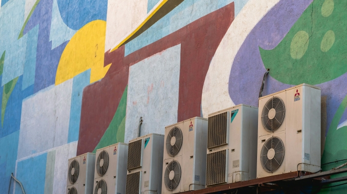 Patterns of the wall of the Bahman cinema and a row of split air conditioners.